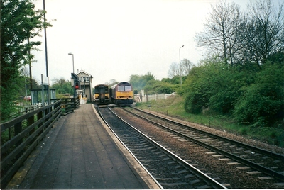 Ulceby station with both passenger and freight trains approaching