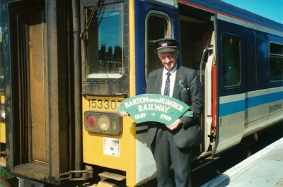 John Chapman with the sesquicentenary head board